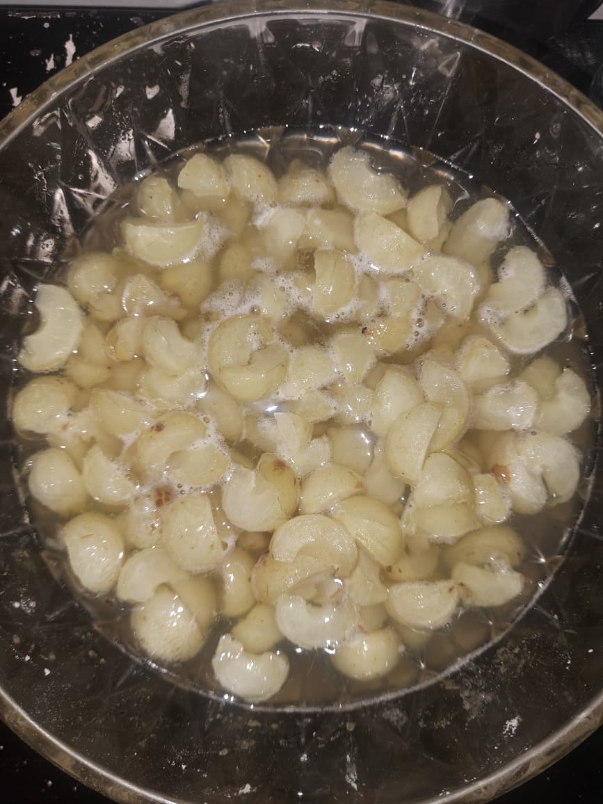 Amla segments soaking in water for candy