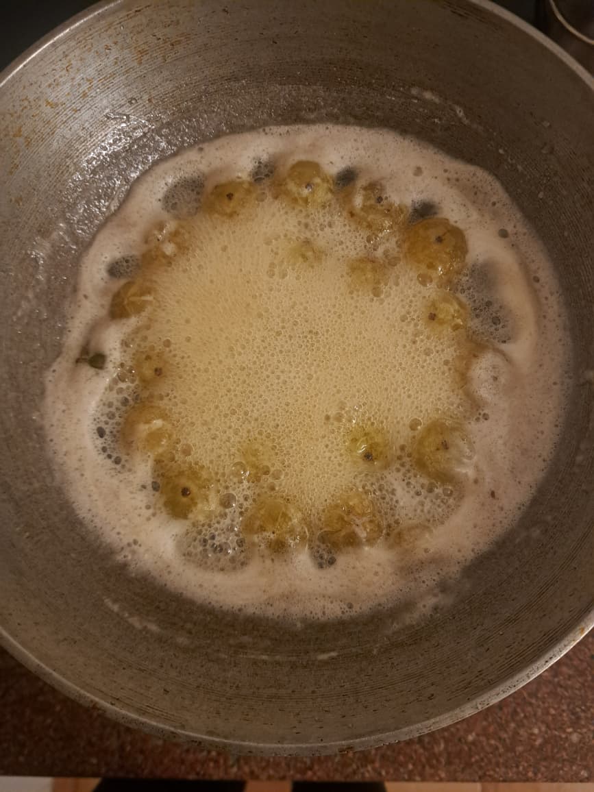 Whole Amla simmering in sugar syrup for murabba
